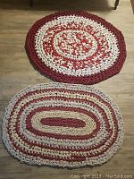Two hand made up-cycled rag rugs laid on wooden floor, one round and one oval.