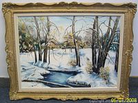 Full view of the oil painting in its ornate gold frame showing a winter scene with snow, trees, a stream, and a cabin.