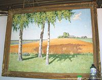 Full view of framed oil painting depicting birch trees and wheat field