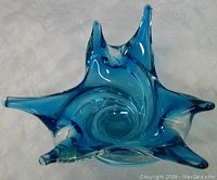 Top view of the blue glass vase showing central opening and eight elongated points