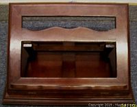 Top view of the wooden adjustable swivel book stand showing rectangular cutouts and smooth dark finish with brass hinges.