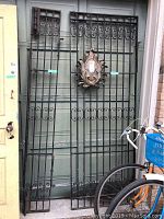 Front view of both coil scrollwork panels leaning against garage door
