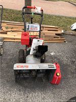 Front view of snowblower showing chute, auger housing and control handles