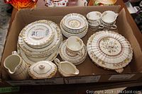 Full overview of china set in shipping box showing all pieces grouped