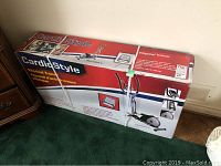Boxed CardioStyle elliptical trainer showing front and top views with product images and branding.