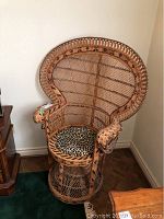 Front view of wicker peacock chair with leopard print cushion on seat