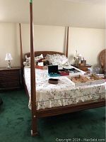 Front view of bed showing headboard, footboard and bedding