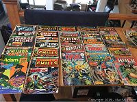 Photo showing a spread of vintage comics including The Witching Hour, Chamber of Chills, Adam-12, The Living Vampire, and others on a table