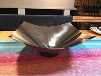 Front view of the square-shaped stainless steel bowl with slightly upturned corners.