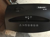 Top view of a black Fellowes W-16C paper shredder with control dial and label.