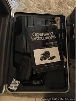 Panasonic VHS camcorder inside carrying case with instruction manual visible
