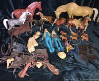 Overview of collection showing large and medium horse figures, cowgirl dolls, various accessories like saddles and hats.