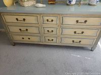 Front view of the full dresser showing nine drawers and overall painted finish, highlighting size and drawer arrangement.