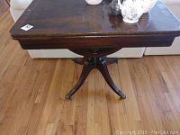 Top view of antique brown wooden rectangular table showing surface wear and scratches.