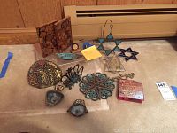 Full view of the Judaica and souvenirs collection showing brass, enamelware, stained glass Star of David, and a wooden map box on the floor.