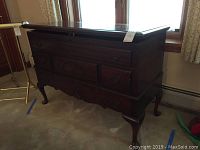Front angled view of cedar wooden lane chest showing the left side and three drawers with decorative handles and carving on the central drawer.