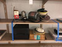 Overview of lot including electric motor with sanding discs and multiple attachments arranged on shelves.