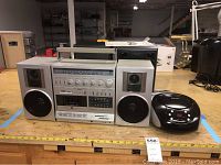 Front view of General Electric stereo model 35267A with two speakers, small black Craig CD player on right side, cords visible around.