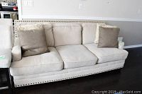 Front view of sofa showing three cushions and two throw pillows