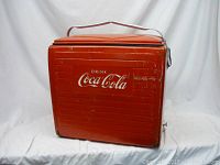 Front view of red Coca-Cola cooler showing logo and ribbed panel design