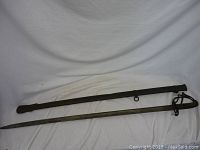 Full view of sword and scabbard laid side by side on white background