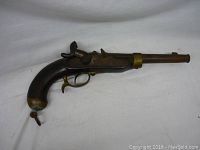 Full left-side profile view of pistol showing barrel, stock, hammer and trigger guard