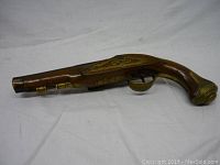 Left profile showing wooden stock, brass inlay along forestock and barrel fittings
