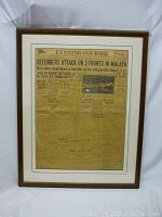 Full view of the framed newspaper showing wood frame and newspaper condition