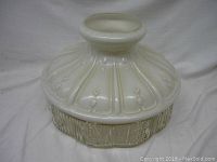 Full view of the vintage white painted glass lampshade showing the top circular opening and floral relief designs on the upper dome shape.