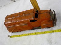 Orange metal vintage toy bus shown from a top angle with ruler measuring around 12 inches in length