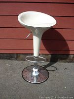 Front view of the white fibreglass barstool with chrome base and adjustable height lever.
