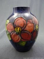Front view showing Clematis floral design on cobalt blue background