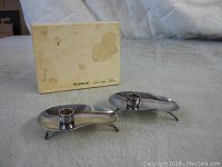 Pair of mid century metal candlesticks shown with original box stained and worn with age.