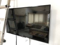 Front view of LG flat panel TV mounted on wall