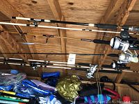 Overhead view of multiple rods and reels mounted on wooden rack