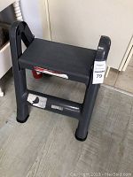Small black plastic stepladder viewed from front and side angles