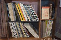 Shelf of vinyl LP albums including titles like 'Great Piano Master Pieces' and 'Glenn Miller', various albums stacked upright and horizontally stored.