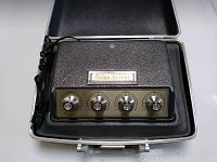 Top view of the electronic device with control panel visible inside the open carrying case.