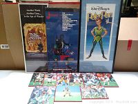 Framed posters of 'The Dark Crystal', 'Jumanji', and Walt Disney's 'Peter Pan' behind an array of football sports photo tiles on the floor