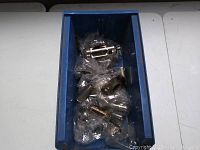 Blue plastic container holding multiple vintage electronic vacuum tubes, each individually bagged in clear plastic for protection.