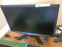 Front view of the Acer 23-inch monitor with cables visible in background