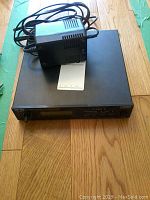 Front view of Boss SE-50 stereo effects processor with AC adapter and cables on top