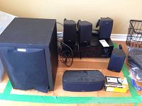 Overall view of receiver, speakers and subwoofer on hardwood floor