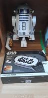 Photo showing battery operated R2D2 model and boxed Star Wars pancake maker with label and pancake images on box.