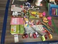 Photo showing entire assortment of scrapbooking materials including paper punches, sticker books, craft cords, glue gun and heat tool