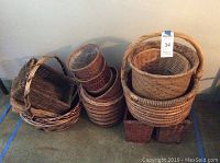 Photo showing multiple wicker baskets stacked and grouped, various shapes and sizes.