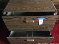 Front view with drawers partially open showing wood grain laminate and wooden handles