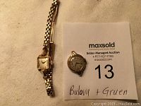 Photo showing the front side of two ladies vintage wristwatches from Bulova and Gruen brands with the auction tag.