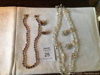 Full set of vintage bead and crystal jewelry including two necklaces and matching clip-on earrings set on white background.
