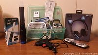 Entire lot of label makers, headset, and tools arranged on wooden surface